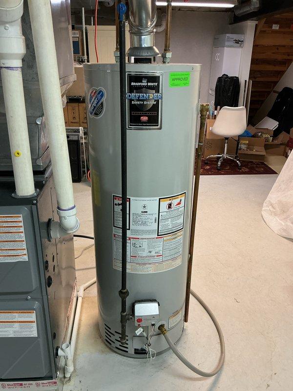 Provided estimate for tankless water heater replacement to address existing 15-year-old Bradford White Defender conventional tank water heater experiencing popping noise during operation. Evaluated current basement installation including gas supply line, copper piping connections, venting system, and clearance requirements for potential tankless conversion. Documented existing equipment configuration and utility connections to determine proper sizing and installation specifications for tankless unit replacement.
