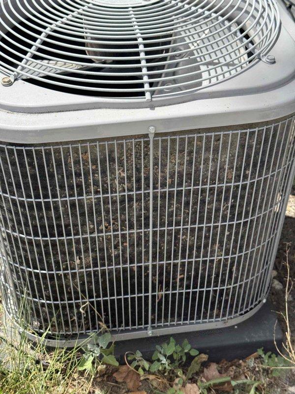 Responded to no cooling complaint on 10+ year old air conditioning system. Upon arrival, found outdoor condensing unit running but not providing adequate cooling. Performed visual inspection revealing heavily soiled condenser coil with significant debris accumulation restricting airflow through fins. Measured compressor amperage at 88.75 amps using clamp meter to verify electrical operation. Accessed electrical panel to inspect capacitor, contactor, and wiring connections. Condenser coil required thorough cleaning to restore proper heat transfer and system efficiency. Unit operational at time of service with blower circulating air but cooling capacity compromised due to restricted condenser airflow from dirt buildup.