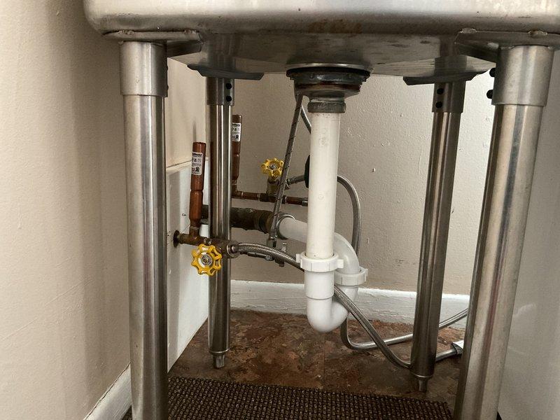 Responded to persistent "dancing pipes" noise complaint in 1967-built home, occurring between laundry room and half bath on main floor for four years despite previously installed water hammer arresters. Performed diagnostic assessment of plumbing system, identifying inadequate pipe strapping as the source of vibration and noise. Strategically removed minimal sections of drywall to access affected pipe runs, installed additional pipe strapping and support brackets to secure loose copper supply lines, and verified elimination of noise through multiple fixture operation tests.