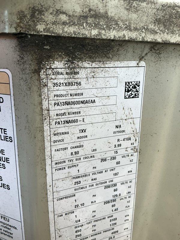 Completed comprehensive Gold AC inspection on 5-year-old Payne residential cooling system, Model PA13NA060-E, Serial 9521X68756, utilizing R-410A refrigerant. Inspected outdoor condenser unit located on concrete pad adjacent to building, noting operational fan assembly with protective grille intact, and basement-located air handler/coil. Unit confirmed operational with all components functioning within normal parameters; documented equipment specifications and current condition with photographic evidence.
