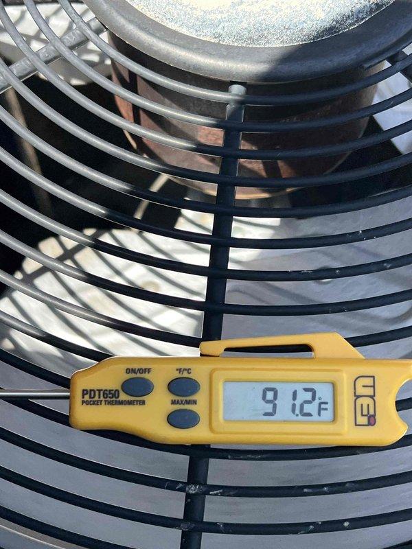Responded to service call regarding non-operational condenser unit on 2015 AC system with basement air handler. Upon arrival, performed diagnostic inspection of outdoor condenser unit and confirmed fan motor failure, though homeowner reported adequate cooling performance during equipment malfunction. Conducted temperature and operational testing, documenting ambient conditions at 91.2°F and verifying unit levelness. Identified condenser fan not running while compressor remained operational, explaining temporary cooling capability. Provided diagnosis and repair recommendations to restore full system functionality.