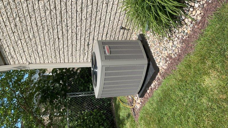 Completed full HVAC system installation including a 70,000 BTU furnace and 2.5 ton rear-discharge air conditioning unit. Installed S40 thermostat, 500M humidifier, condensate pump, and performed system flush. Obtained mechanical, plumbing, and electrical permits for the installation. Reconnected all utilities, verified proper operation of all components, and documented AHRI reference number 215663829 for equipment matching certification. System qualified for utility rebate programs and was photographed showing the outdoor condenser unit properly positioned on concrete pad with appropriate clearances and landscaping.