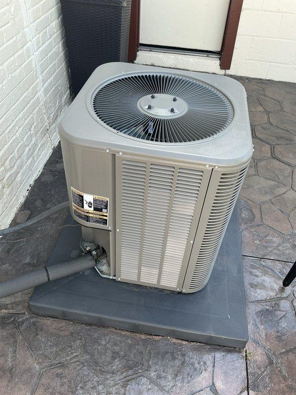 Completed comprehensive Gold AC inspection on 2-year-old residential air conditioning system with air handler located in basement. Performed thorough examination of outdoor condenser unit, confirmed proper operation of all components including condenser fan, verified refrigerant lines are secure and free from damage, and assessed overall equipment condition. Unit found in excellent working order with clean exterior surfaces, properly mounted on composite pad, clear surrounding area free of debris, and no visible signs of wear, damage, or system concerns requiring immediate attention.