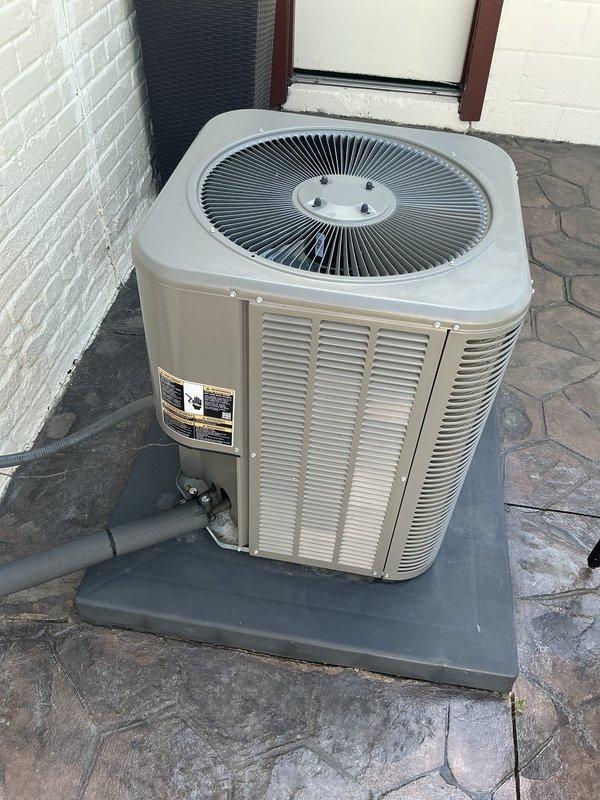 Completed comprehensive Gold AC inspection on 2-year-old residential air conditioning system with air handler located in basement. Performed thorough examination of outdoor condenser unit, confirmed proper operation of all components including condenser fan, verified refrigerant lines are secure and free from damage, and assessed overall equipment condition. Unit found in excellent working order with clean exterior surfaces, properly mounted on composite pad, clear surrounding area free of debris, and no visible signs of wear, damage, or system concerns requiring immediate attention.