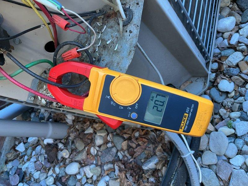 Completed comprehensive Gold AC inspection on a two-unit residential HVAC system with air handler located in attic. Performed detailed electrical diagnostics on outdoor condensing unit, measuring amperage draw at 31.9 amps using clamp meter to verify compressor performance within manufacturer specifications. Inspected capacitor, contactor, and all electrical connections for signs of wear, corrosion, and proper operation. Evaluated condenser coil condition, airflow through louvers, and overall system functionality. All components found operating normally with equipment responding appropriately to cooling demand. System confirmed in good working order at time of inspection.