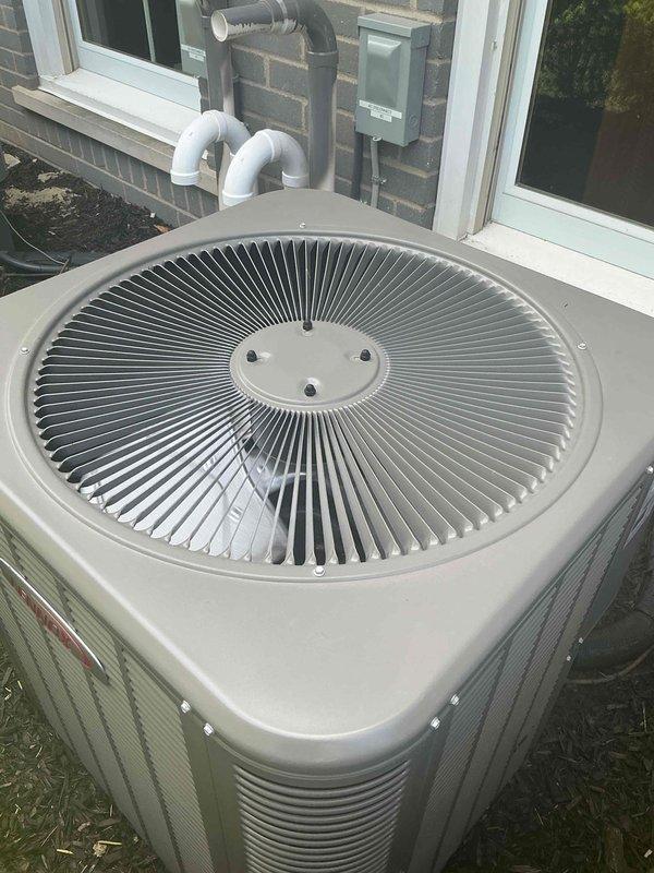 # HVAC Maintenance - Gold AC Inspection

Performed comprehensive spring maintenance on a 2-year-old Lennox air conditioning system at a residential property. The outdoor condenser unit, positioned on a concrete pad in the side yard, was in excellent operational condition with clean exterior surfaces and proper clearances maintained around the unit.

## Inspection and Testing Procedures

Conducted thorough visual inspection of the condenser unit, confirming all exterior panels, louvers, and top grille assembly were intact and secure. Verified proper mounting of center fan cap with all fasteners tight. Inspected the concrete pad for levelness and stability with no settling or deterioration noted.

Examined refrigerant line set and PVC condensate drain piping routed along the brick exterior wall. All piping connections were secure with no signs of leakage, damage, or UV deterioration. Electrical disconnect box mounted on exterior wall was inspected and found in proper working order.

## M