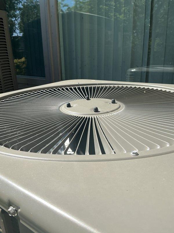 Completed comprehensive Gold AC Inspection and tune-up on outdoor condensing unit located in backyard. Performed full system evaluation including visual inspection of cabinet, fan assembly, and refrigerant lines; cleaned condenser coils and removed debris from top grille; checked electrical connections and components; verified proper refrigerant pressures and system operation. Unit showed normal wear consistent with outdoor exposure but maintained structural integrity with no significant deterioration noted. All components functioning within manufacturer specifications upon completion of preventive maintenance service.