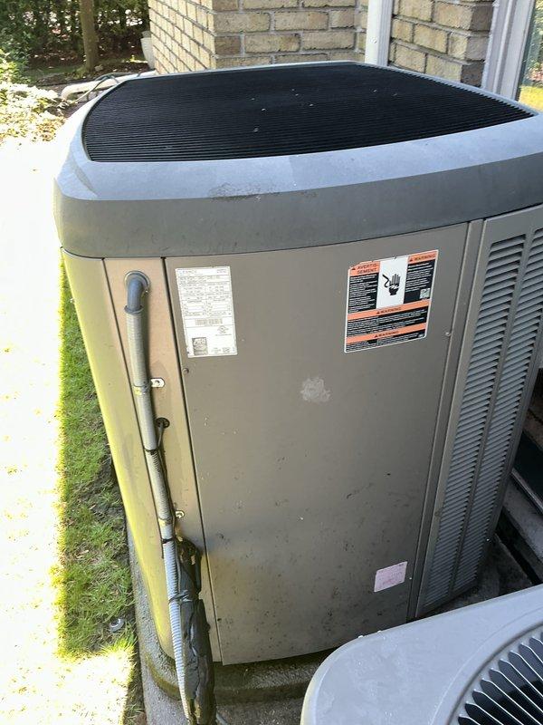 Completed comprehensive Gold AC Inspection and tune-up on outdoor condensing unit located in backyard. Performed full system evaluation including visual inspection of cabinet, fan assembly, and refrigerant lines; cleaned condenser coils and removed debris from top grille; checked electrical connections and components; verified proper refrigerant pressures and system operation. Unit showed normal wear consistent with outdoor exposure but maintained structural integrity with no significant deterioration noted. All components functioning within manufacturer specifications upon completion of preventive maintenance service.