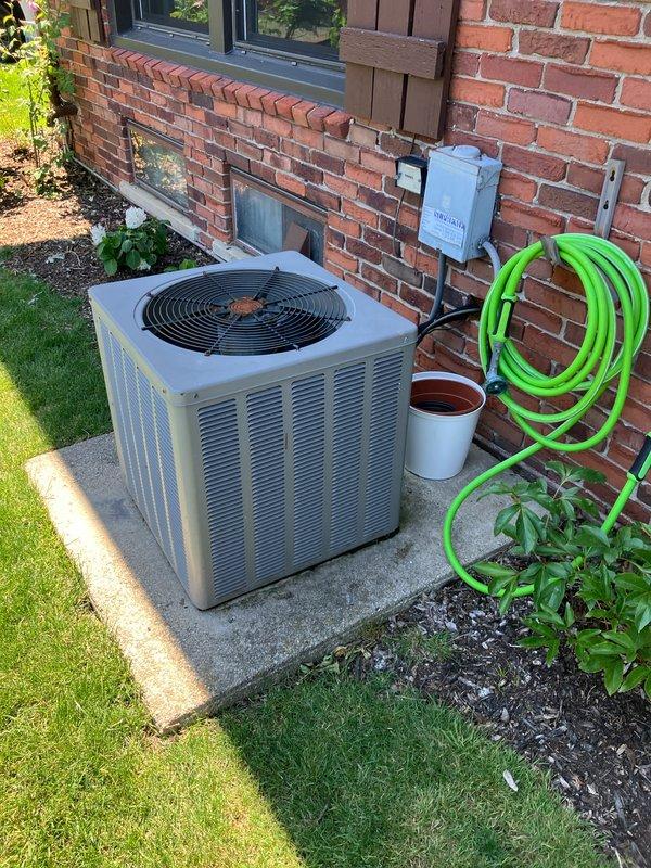 Completed full system replacement estimate for 22-year-old furnace with cracked primary heat exchanger and 20-year-old R22 air conditioning unit experiencing abnormal operational sounds, overheating issues, and failing outdoor fan motor bearings. Assessed existing equipment located at basement level with outdoor condenser positioned on concrete pad adjacent to brick exterior wall. Documented current system conditions and provided comprehensive replacement options for complete HVAC system upgrade.
