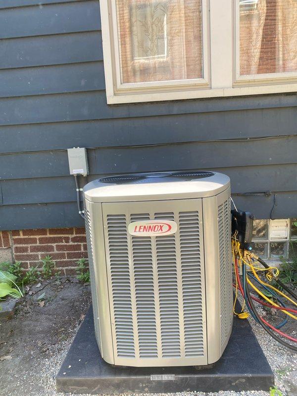 Completed installation of new Lennox air conditioning system with matching evaporator coil. Positioned condensing unit on concrete pad in rear yard against exterior wall with proper clearances for airflow and service access. Installed new electrical circuit and disconnect box to code specifications. Ran refrigerant lines between outdoor condensing unit and indoor coil, evacuated system, and charged to manufacturer specifications. Connected indoor evaporator coil to existing furnace in basement. Verified all electrical connections, tested system operation, and confirmed proper cooling performance. Obtained mechanical, electrical, and AC permits as required.