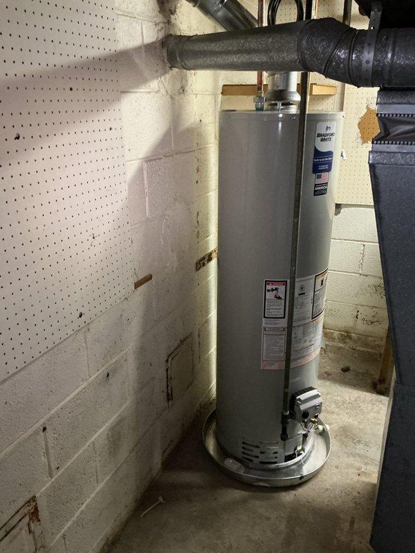 Installed a 40-gallon tall/skinny residential water heater in basement utility room with required drip pan and alarm system. Connected all water supply lines, gas line, and venting system to manufacturer specifications, ensuring proper operation of digital control panel and safety features. Installation completed in accordance with local plumbing codes and industry standards.