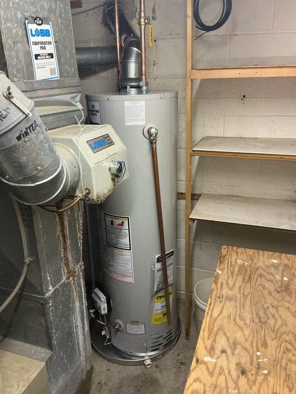Installed a 40-gallon tall/skinny residential water heater in basement utility room with required drip pan and alarm system. Connected all water supply lines, gas line, and venting system to manufacturer specifications, ensuring proper operation of digital control panel and safety features. Installation completed in accordance with local plumbing codes and industry standards.