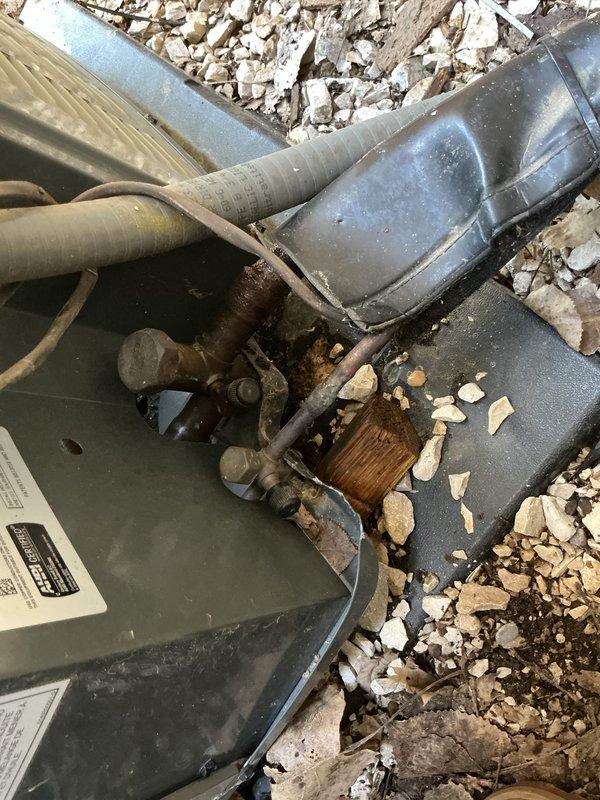 Completed comprehensive cooling system inspections on two residential air conditioning units, including one Trane condenser unit and one additional condensing unit located outdoors against exterior wall. Performed visual assessment of both outdoor condenser units, verified fan operation and mechanical components, and inspected electrical connections with junction boxes mounted on exterior wall. Noted significant rust and corrosion present at ductwork connection joints on one unit requiring monitoring, with deteriorated protective coating exposing oxidized metal surfaces. Inspected basement-located air handler and evaporator coil assembly. Documented equipment condition through photographic records showing overall functional status of both systems with minor weathering consistent with outdoor installation exposure.