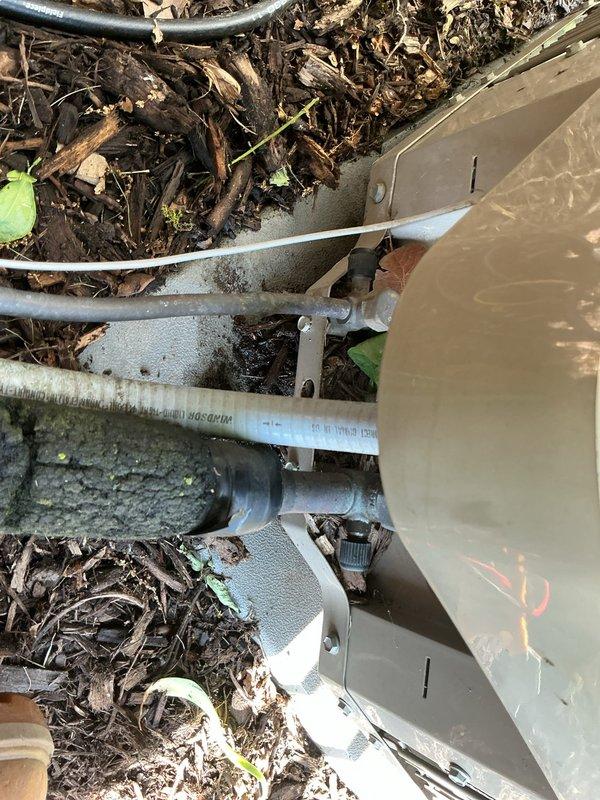 Responded to service call for central air conditioning system running but not producing adequate cooling. Upon inspection, discovered evidence of refrigerant leak at outdoor condensing unit connections, indicated by oil staining on mounting bracket and surrounding components. Identified leak source at service valve connections, performed leak repair, evacuated system, and recharged unit to manufacturer specifications. Verified proper system operation with temperature differential testing and confirmed return to normal cooling capacity.