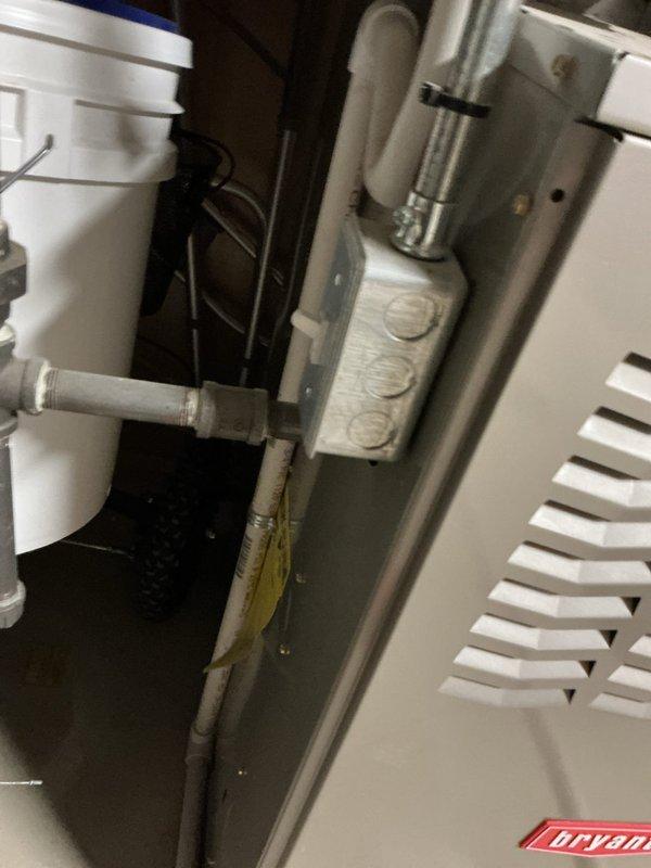 Responded to service call for central air conditioning system running but not producing adequate cooling. Upon inspection, discovered evidence of refrigerant leak at outdoor condensing unit connections, indicated by oil staining on mounting bracket and surrounding components. Identified leak source at service valve connections, performed leak repair, evacuated system, and recharged unit to manufacturer specifications. Verified proper system operation with temperature differential testing and confirmed return to normal cooling capacity.