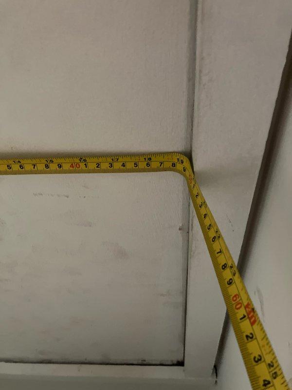 Responded to service call for non-cooling air conditioning system with active refrigerant leak located in attic space with extremely limited access. Ten-year-old system had completely failed, with history of water leakage through ceiling from previous season. Performed comprehensive system evaluation in confined attic installation, documented tight clearances and access constraints with measurements, and assessed air handler condition and leak source. Provided complete equipment replacement estimate due to age of system, active leak, and accessibility challenges for repair work.