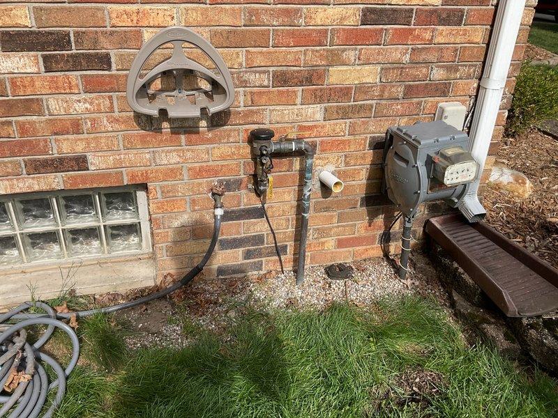 Responded to water leak at pressure vacuum breaker (PVB) assembly on east side of residential property. Upon arrival, identified active leak at female brass union connection between PVB and main water supply line, which began when water was restored that morning. Inspected corroded plumbing assembly mounted on exterior brick wall, noting significant rust and deterioration on metal components and water staining on surrounding masonry. Repaired faulty connection at brass union fitting to eliminate leak and restore proper seal. Verified system integrity and confirmed leak was isolated to this connection point with no impact to interior plumbing. Tested water flow after repair to ensure proper operation of PVB and supply line without further leakage.