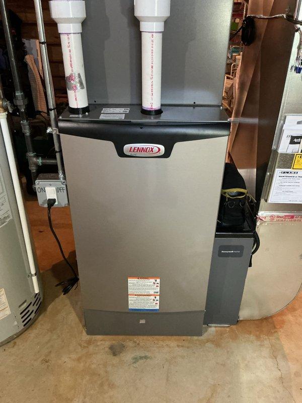 Completed comprehensive Gold AC Inspection on 1-year-old Lennox HVAC system with air handler located in basement. Performed multi-point inspection including evaluation of furnace operation, verification of electrical disconnect functionality, inspection of PVC intake and exhaust venting systems, assessment of copper refrigerant lines, and examination of all accessible components. System found to be operating within normal parameters with no deficiencies noted during inspection.
