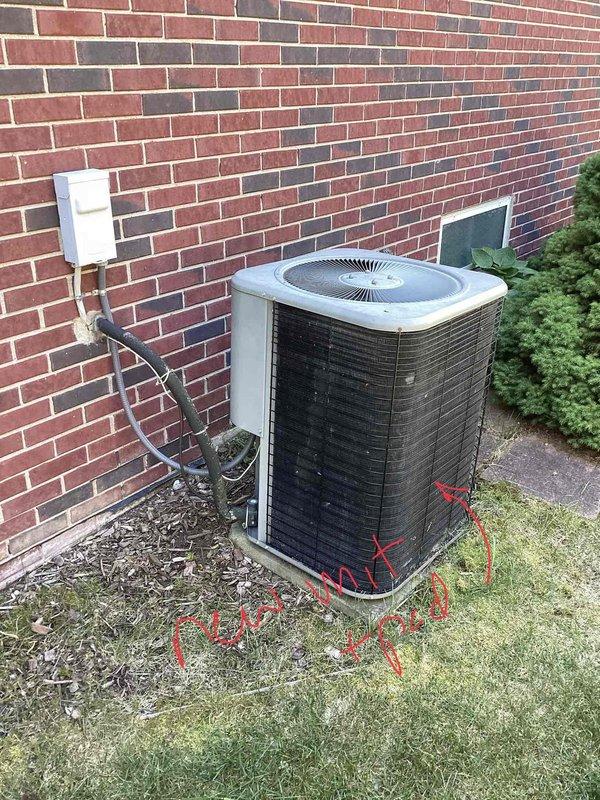 Conducted comprehensive site evaluation for full HVAC system replacement at residential property. Assessed existing outdoor air conditioning condenser unit positioned on concrete pad adjacent to brick exterior wall, noting current electrical disconnect configuration and conduit routing. Evaluated interior furnace and air handler installation in basement mechanical room, including existing ductwork layout with galvanized metal supply and return plenum connections. Documented current system specifications, electrical service requirements, and structural mounting considerations for equipment replacement. Photographed outdoor condenser unit showing utility markings on ground and current electrical connections, as well as basement air handler with flexible and rigid ductwork distribution system mounted to painted masonry wall. Prepared detailed measurements and specifications for new furnace and air conditioning system installation, accounting for existing infrastructure, clearance requirem