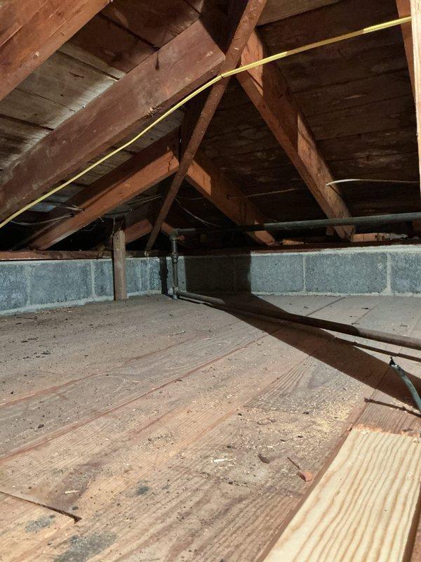 Completed plumbing estimate for installation of new gas lines under residential structure. Assessed crawlspace and attic areas to determine routing requirements, existing utility locations, and structural considerations for proper gas line installation. Documented current conditions including exterior utility connections near HVAC equipment and interior access points through unfinished attic space with exposed framing and concrete block foundation walls.