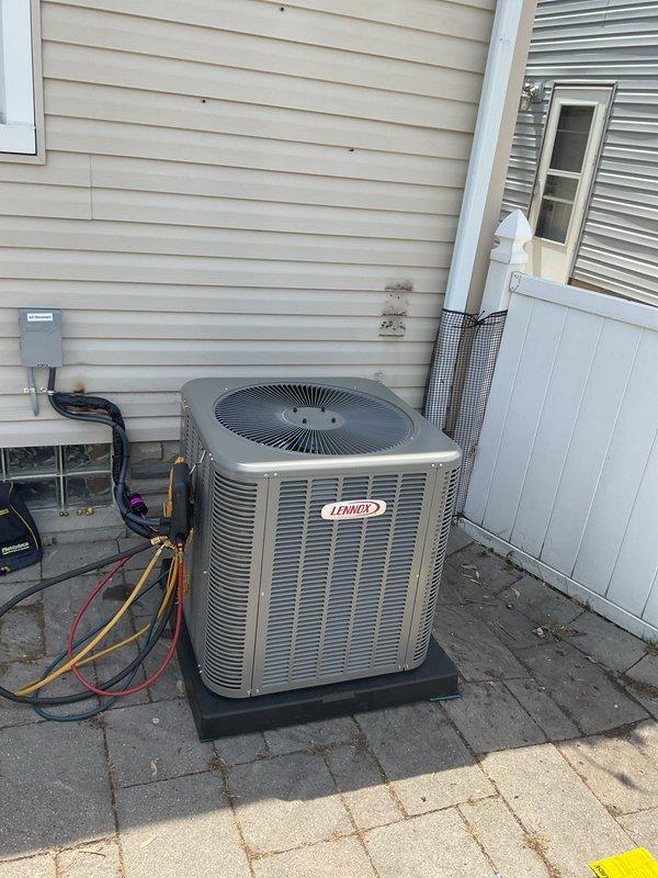 Completed installation of 2.5-ton air conditioning system with evaporator coil replacement. Outdoor condensing unit (Lennox model) was upgraded from originally specified equipment due to availability constraints, with all parties approving the substitution prior to installation. Unit mounted on composite pad with proper clearances, connected via copper refrigerant lines and electrical conduit to new disconnect box. Indoor evaporator coil installed in basement mechanical room with PVC condensate drainage properly routed. System evacuated, charged to manufacturer specifications, and tested for proper operation. Electrical work noted as requiring licensed electrician for final connections and code compliance. Mechanical, electrical, and air conditioning permits secured prior to commencement of work. All refrigerant lines insulated, system operational upon completion of electrical hookup.