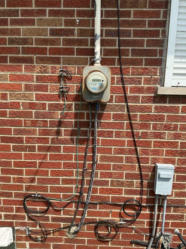 Provided comprehensive estimate for complete HVAC system replacement at residential property with 40+ year old air conditioning unit currently located in basement. Assessed existing natural gas furnace and air conditioning equipment, evaluated electrical service connections and metering infrastructure at exterior brick wall, and documented site conditions to develop replacement specifications for new heating and cooling system.