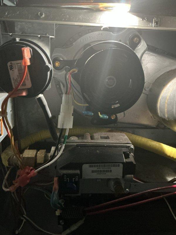 Replaced defective inducer motor assembly on furnace system. The new motor was retrieved from the shop and successfully installed, with all electrical connections properly secured to the control module and wiring harness verified for correct operation.