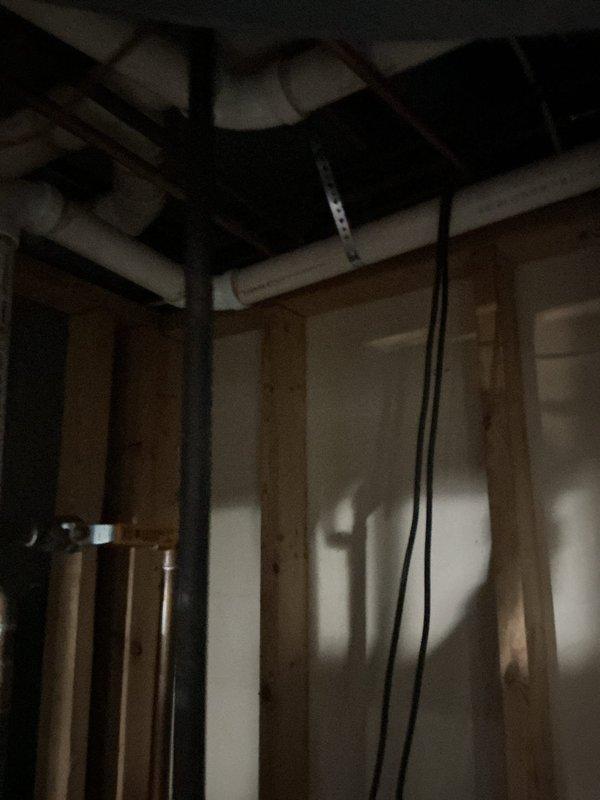 Returned to complete power vent water heater venting repair with materials retrieved from shop. Installed proper PVC venting configuration through exterior wall with secure mounting and appropriate fittings, ensuring code-compliant exhaust termination and intake air supply for safe water heater operation.
