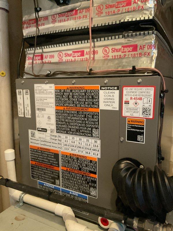 Successfully completed installation of a 2-ton air conditioning system with matching evaporator coil in utility space. Installed new condensing unit with R-454B refrigerant, connected refrigerant lines, and integrated Ecobee 3 Lite thermostat for system control. Performed system flush, established proper drainage with PVC condensate lines, secured all electrical and mechanical connections, and verified operational parameters. All required mechanical, electrical, and air conditioning permits obtained and work completed to code specifications.