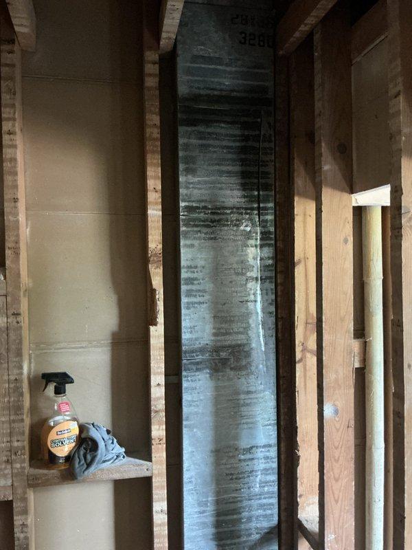 Responded to service call for assessment and quote on replacement vents for 10+ year old heating and cooling system. Upon inspection, discovered severely deteriorated ductwork and air handler components in unfinished interior space with visible water damage, heavy discoloration, and accumulated contamination on metallic duct surfaces. Documented existing conditions including compromised galvanized ductwork with significant grime buildup in corrugations and evidence of moisture intrusion affecting system integrity. Photographed installation for quote preparation on complete vent and ductwork replacement to restore proper indoor air quality and system performance.