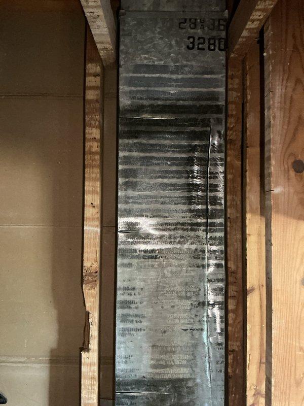 Responded to service call for assessment and quote on replacement vents for 10+ year old heating and cooling system. Upon inspection, discovered severely deteriorated ductwork and air handler components in unfinished interior space with visible water damage, heavy discoloration, and accumulated contamination on metallic duct surfaces. Documented existing conditions including compromised galvanized ductwork with significant grime buildup in corrugations and evidence of moisture intrusion affecting system integrity. Photographed installation for quote preparation on complete vent and ductwork replacement to restore proper indoor air quality and system performance.