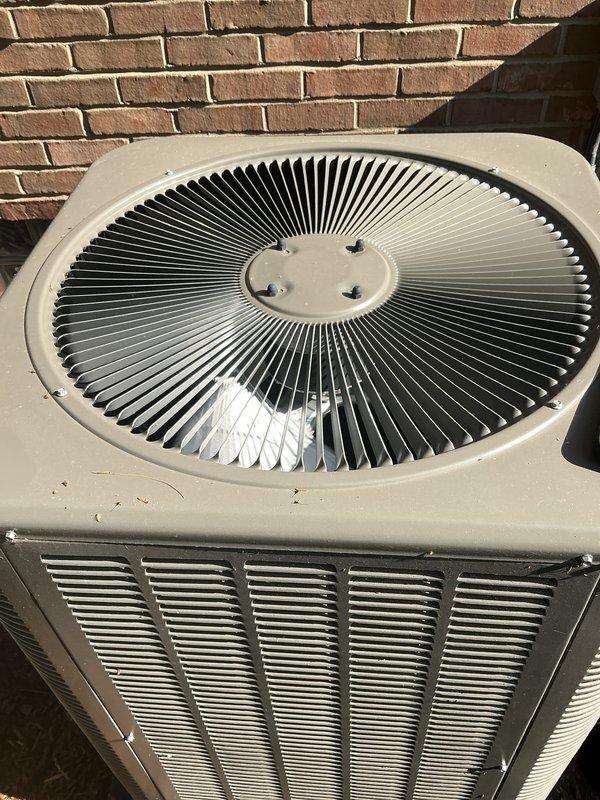 Completed comprehensive Gold AC inspection on a 1-year-old Lennox two-unit residential system with air handler located in basement. Performed thorough examination of outdoor condensing unit, verified proper operation of fan assembly and compressor, inspected ventilation slats and housing for adequate airflow, confirmed unit is free of debris and maintaining proper clearances from structure. All components found to be in excellent condition with no visible damage, rust, or deterioration, and system operating within normal parameters.