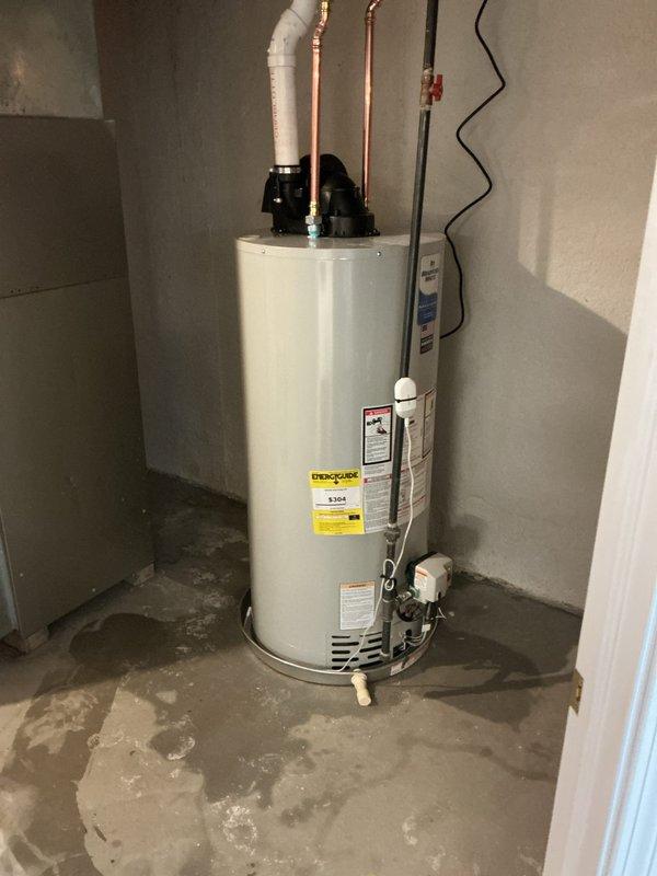 Completed installation of a 50-gallon power vent water heater in residential basement utility area. Installed new copper supply lines with appropriate shut-off valves, connected gas line with proper valve assembly, and integrated recirculation pump system at top of unit. Configured power vent exhaust system with PVC venting, established electrical connections for pump and control systems, and verified all safety controls and temperature pressure relief valve operation. All connections tested and confirmed leak-free, unit commissioned and operational per manufacturer specifications.
