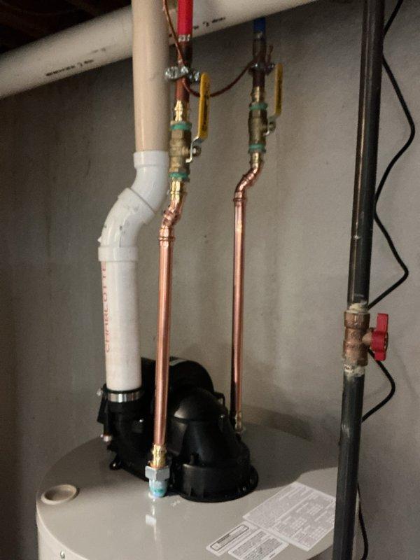 Completed installation of a 50-gallon power vent water heater in residential basement utility area. Installed new copper supply lines with appropriate shut-off valves, connected gas line with proper valve assembly, and integrated recirculation pump system at top of unit. Configured power vent exhaust system with PVC venting, established electrical connections for pump and control systems, and verified all safety controls and temperature pressure relief valve operation. All connections tested and confirmed leak-free, unit commissioned and operational per manufacturer specifications.