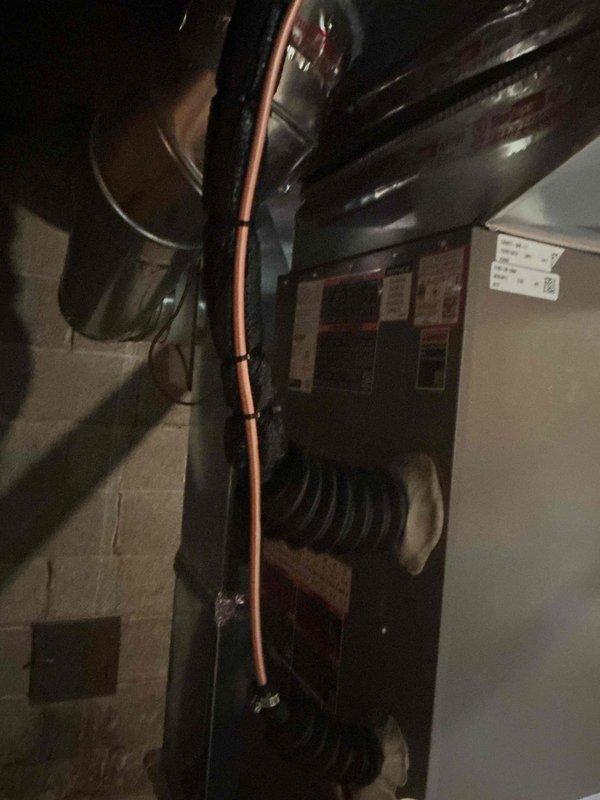 Completed installation of new air conditioning system and evaporator coil in residential basement location. Installed air handler unit with proper refrigerant line connections, integrated with existing furnace and ductwork infrastructure. Routed copper refrigerant lines vertically through mechanical space, ensuring proper insulation and support. Connected new coil to supply plenum with appropriate sealing and insulation at connection points. Verified all electrical connections, tested system operation, and confirmed proper airflow through ductwork. Permit requested for installation as required by local code.