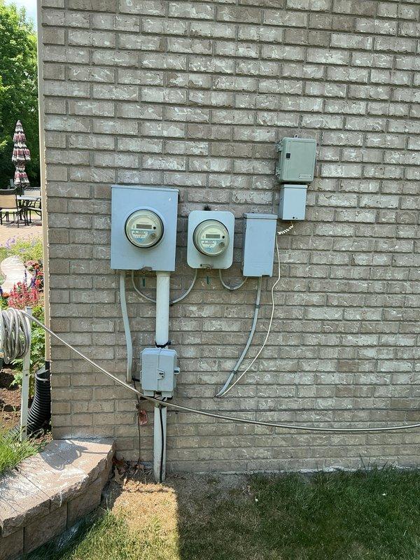 Conducted on-site evaluation for whole home generator installation at residential property. Assessed existing electrical service configuration including dual meter assembly, main service panels, and disconnect equipment mounted on exterior brick wall. Documented current electrical infrastructure and available space for generator placement, confirming compatibility requirements for transfer switch integration with existing 200-amp service. Provided consultation regarding whole home generator options versus portable generator hook-up service based on property type and customer requirements.