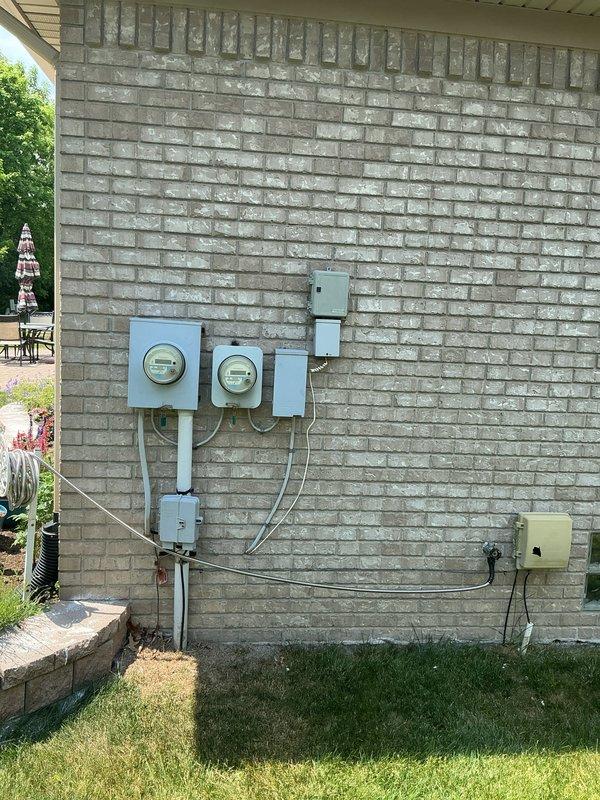 Conducted on-site evaluation for whole home generator installation at residential property. Assessed existing electrical service configuration including dual meter assembly, main service panels, and disconnect equipment mounted on exterior brick wall. Documented current electrical infrastructure and available space for generator placement, confirming compatibility requirements for transfer switch integration with existing 200-amp service. Provided consultation regarding whole home generator options versus portable generator hook-up service based on property type and customer requirements.