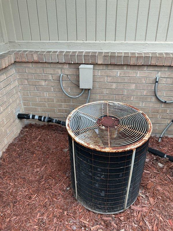 Provided comprehensive estimate for full HVAC system replacement at owner-occupied residence with existing 19-year-old equipment from 2007 currently located in garage. Documented existing indoor air handler unit showing significant wear, dirt accumulation, and staining on concrete floor surface, along with outdoor condenser unit exhibiting extensive rust discoloration on top grille and fan housing, indicating advanced age and weather exposure. Quote prepared for complete system installation to replace aging equipment that has exceeded typical service life expectancy.