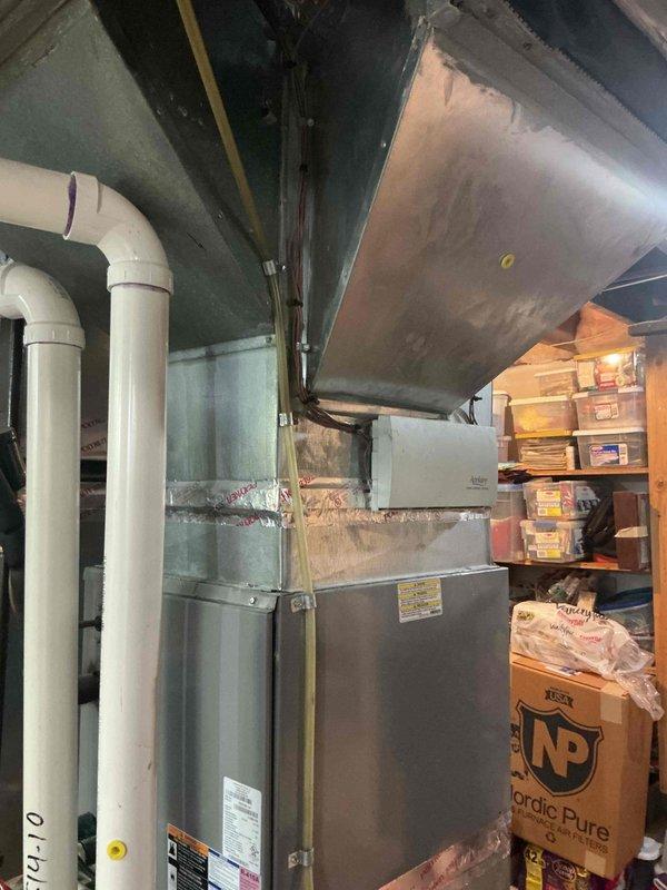 Completed full HVAC system installation consisting of new air conditioning unit and evaporator coil. Performed initial site measurements and remeasurement to ensure proper equipment sizing and fitment within existing utility space. Installed new A/C condenser and matching indoor evaporator coil, connecting refrigerant lines and integrating with existing furnace/air handler. Verified all ductwork connections to main supply plenum and ensured proper condensate drainage through PVC piping system. Submitted AC permit request for required municipal approval. Secured financing documentation and customer identification on file. All equipment installed per manufacturer specifications with proper clearances maintained for service access and code compliance.