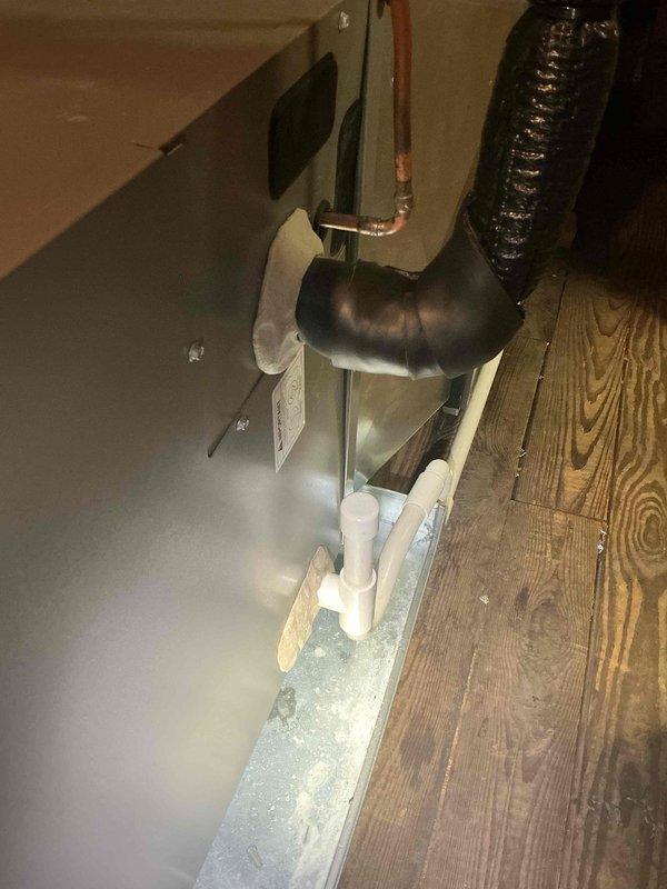 Responded to callback for newly installed AC system with no operation located in third floor attic. Upon inspection, found condensate drain line improperly pitched, causing potential drainage issues that may have contributed to system shutdown. Leveled and adjusted PVC condensate drain line to ensure proper pitch and drainage flow from air handler unit. Verified drain pan was dry and system returned to normal operation with adequate airflow restored.