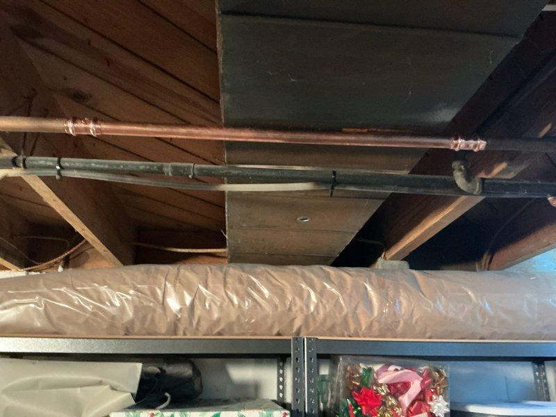 Responded to service call for leaking copper pipe in attic space and dripping bathtub faucet. Inspected copper supply line running through upper level structural area and identified source of leak. Assessed tub/shower fixture with chrome handles and spout in tiled bathroom, diagnosed worn valve seat causing persistent drip, and performed necessary repairs to restore proper function and eliminate water waste.