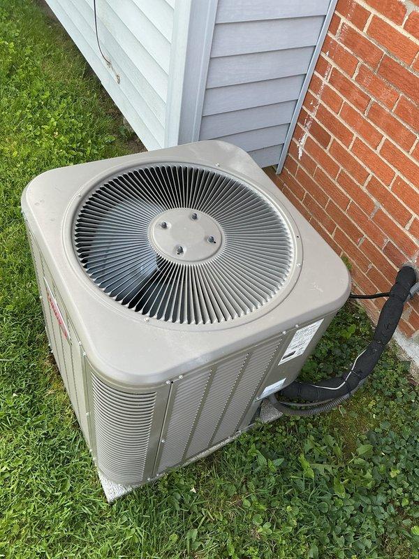 Completed Gold-level preventive maintenance inspection on residential air conditioning system with equipment less than 10 years old. Performed comprehensive evaluation of outdoor condenser unit including visual inspection of cabinet condition, refrigerant line connections, and electrical components. Inspected air handler and evaporator coil assembly located at rear of residence, verified proper airflow, checked condensate drain operation, and assessed overall system performance. All components found operating within normal parameters with no immediate service concerns identified during inspection.