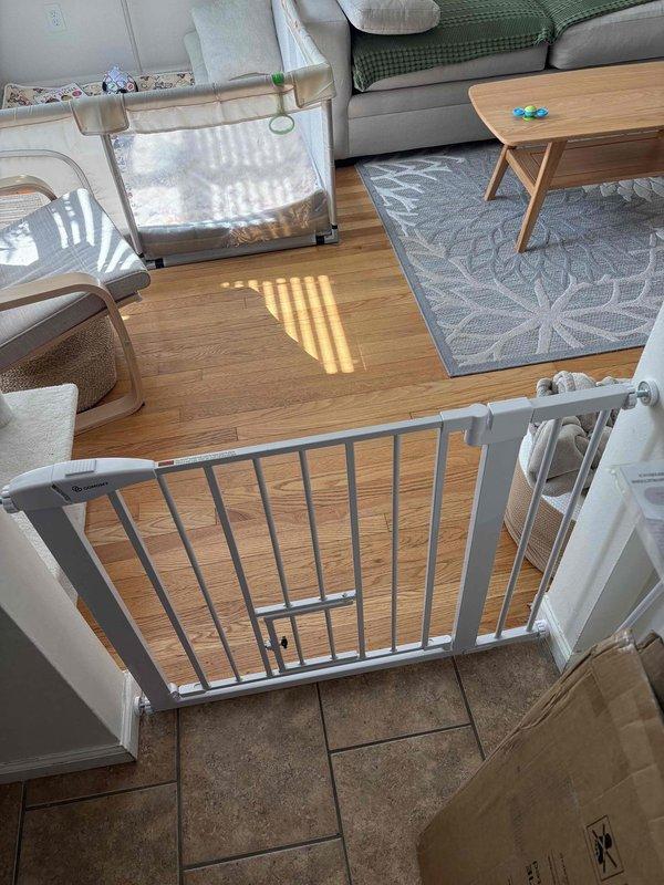Installed three metal child safety gates with vertical bar construction at key locations throughout the residence. Mounted one gate at the top of the carpeted stairway landing with integrated swing-door access panel, and positioned another gate at an elevated platform entrance overlooking the main living area. All gates were securely fastened to existing wall structures and doorframes per manufacturer specifications and safety standards. Verified proper operation of swing mechanisms and confirmed adequate clearance for daily use while maintaining child safety compliance.