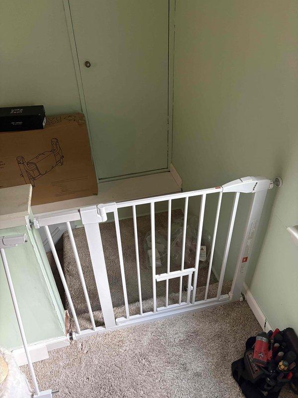 Installed three metal child safety gates with vertical bar construction at key locations throughout the residence. Mounted one gate at the top of the carpeted stairway landing with integrated swing-door access panel, and positioned another gate at an elevated platform entrance overlooking the main living area. All gates were securely fastened to existing wall structures and doorframes per manufacturer specifications and safety standards. Verified proper operation of swing mechanisms and confirmed adequate clearance for daily use while maintaining child safety compliance.
