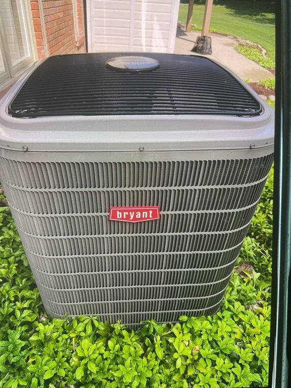 Completed Gold AC Inspection on 10-year-old Bryant air conditioning system with air handler located in basement. Unit operational at time of service. Inspected outdoor condenser unit, which showed signs of dirt accumulation and biological growth on condenser coils requiring attention for optimal efficiency. Documented equipment condition through photographic records showing external components and coil condition. System confirmed operational with single-zone configuration serving residence.