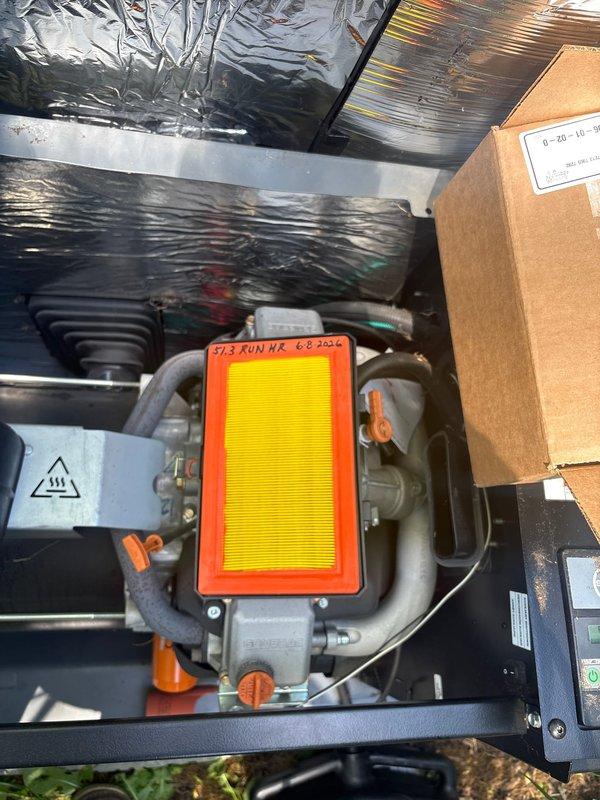 Completed annual maintenance inspection on 22kW Honeywell standby generator per maintenance plan requirements. Inspected control panel displaying SYNC 3.0 interface, verified system status showing next scheduled maintenance at 200 run hours, and confirmed all operational modes (Auto/Manual/Off) functioning properly. Examined air filtration system, noting filter dated 6-8-2024 in serviceable condition, and documented mechanical components including ductwork, connections, and safety warning labels all present and intact.