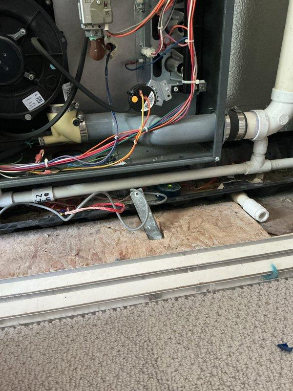Performed comprehensive AC tune-up on 2-year-old outdoor unit with no reported issues. Conducted standard preventive maintenance including inspection of control board, electrical connections, and all wiring harnesses for proper termination and signs of wear. Verified blower motor operation, examined gas valve connections, checked capacitor condition, and inspected all PVC condensate lines and fittings for proper drainage. All components found in good working order with system operating within normal parameters.