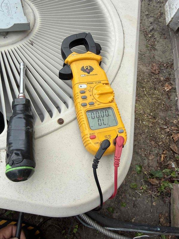 Responded to service call for outdoor condensing unit experiencing knocking noise during startup and shutdown cycles. Upon inspection of the 10+ year old cooling system, diagnosed failing dual-run capacitor as the source of mechanical noise. Verified capacitor degradation using digital clamp meter and confirmed unit specifications (80+5 MFD, 440/370VAC). Replaced defective TITAN HCPD305 motor run capacitor with new component, reconnected all electrical leads, and tested system operation to confirm elimination of knocking noise and proper compressor/fan motor function.