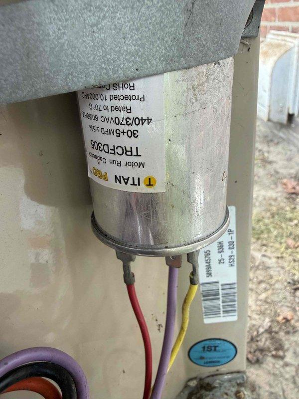 Responded to service call for outdoor condensing unit experiencing knocking noise during startup and shutdown cycles. Upon inspection of the 10+ year old cooling system, diagnosed failing dual-run capacitor as the source of mechanical noise. Verified capacitor degradation using digital clamp meter and confirmed unit specifications (80+5 MFD, 440/370VAC). Replaced defective TITAN HCPD305 motor run capacitor with new component, reconnected all electrical leads, and tested system operation to confirm elimination of knocking noise and proper compressor/fan motor function.