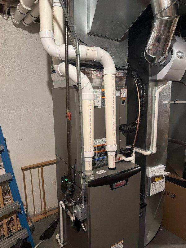 Completed installation of 3-ton air conditioning system with matching evaporator coil for first floor application. Installed new Bryant furnace with air handler in utility room, including proper venting with white PVC piping, condensate drainage system, and electrical connections. Positioned outdoor condensing unit in right side yard with refrigerant line set connection to indoor coil, system startup, and operational testing to manufacturer specifications.